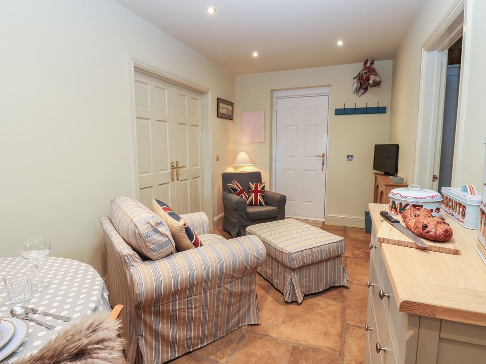 A snug with a couch and dining table at The Annex