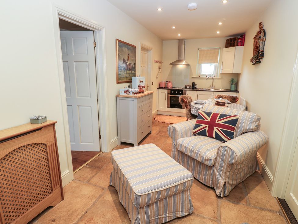 A kitchen area with a chair and table in The Annex