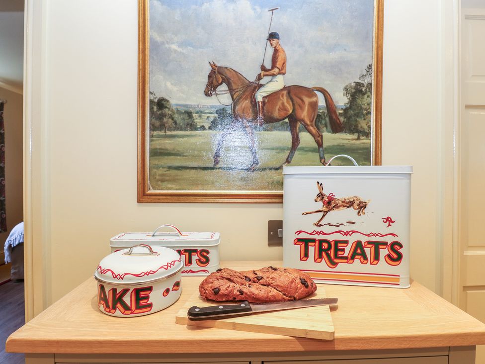 A kitchen with a table containing a knife and bread at The Annex