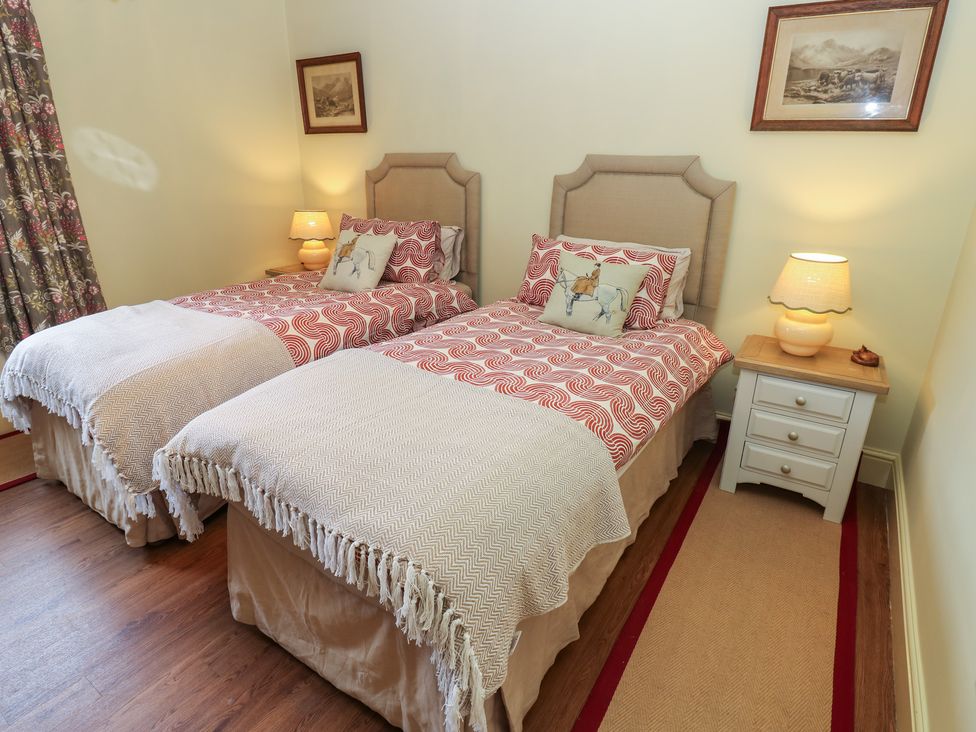 A bedroom with two beds and a bedside table at The Annex