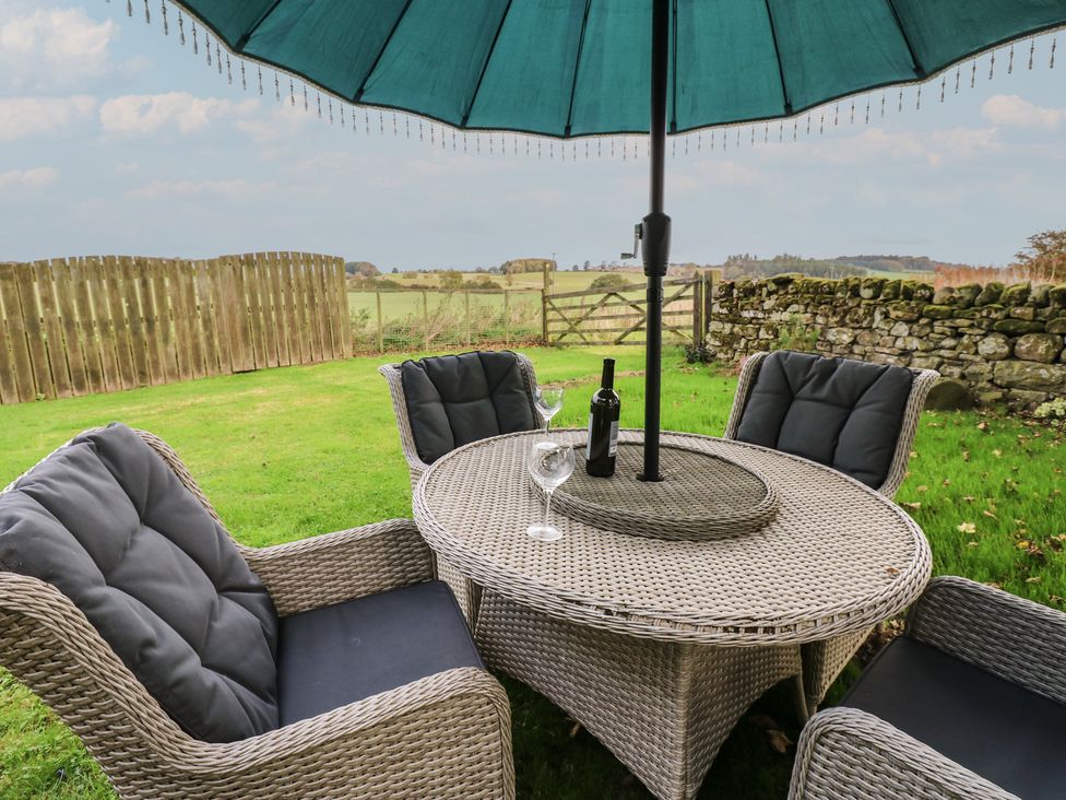 A garden seating area with a table and chairs at The Annex
