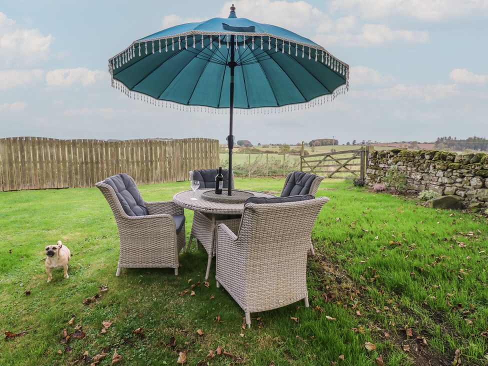 A garden with outdoor furniture and a dog at The Annex 