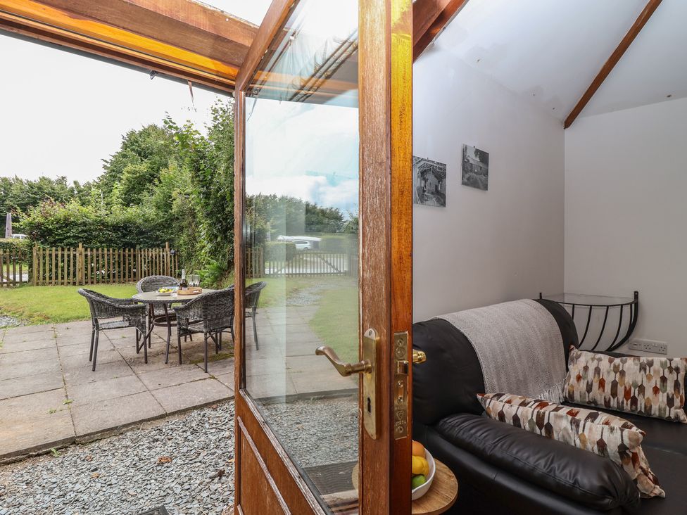 A living room with a view of outdoor seating area at The Coach House in Tavistock