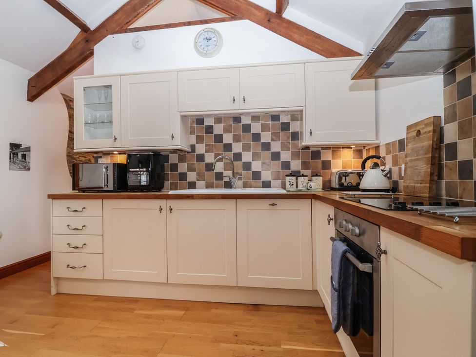 A kitchen with cabinets and appliances at The Coach House in Tavistock
