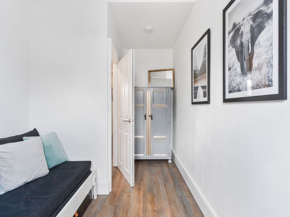A hallway with a sofa and wardrobe at The Sundial St Austell