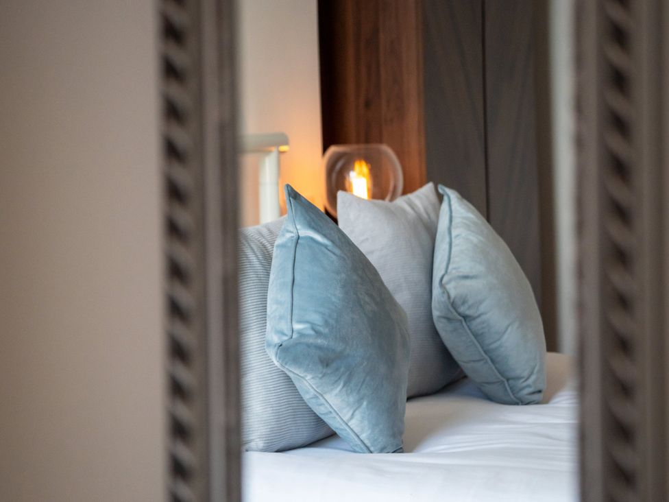 A bedroom with pillows on a bed at The Sundial in St Austell