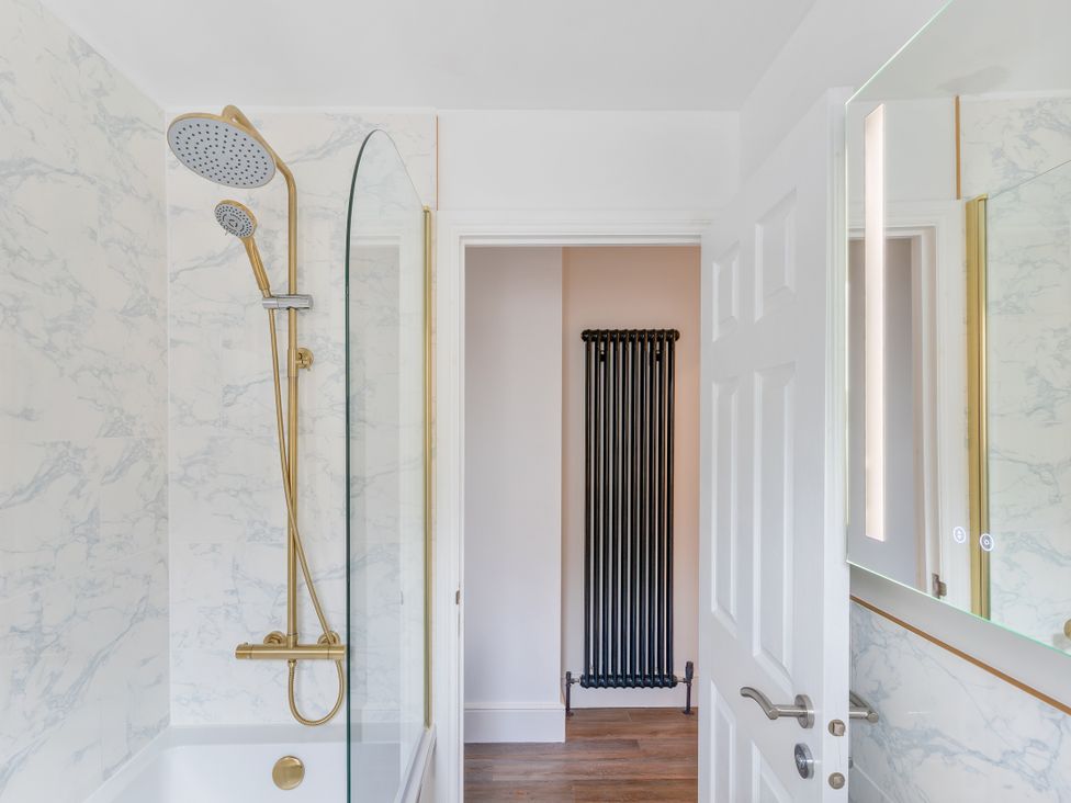 A bathroom with a shower and bathtub at The Sundial in St Austell