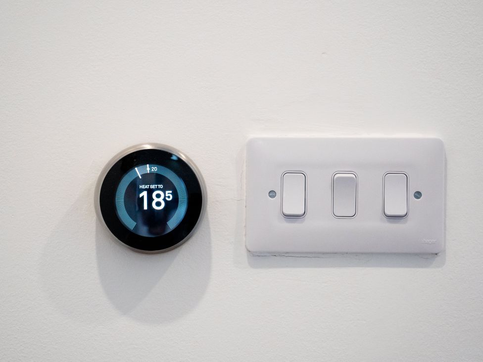 A thermostat and light switches on a wall at The Sundial in St Austell