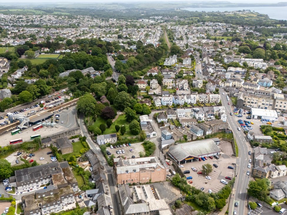 An aerial view of a town with houses, roads, and greenery at The Sundial in St Austell