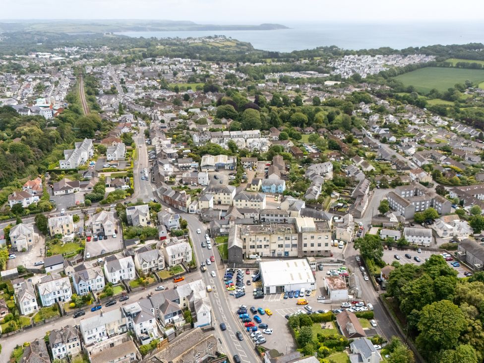 Aerial view of buildings and roads near a coastline at The Sundial in St Austell