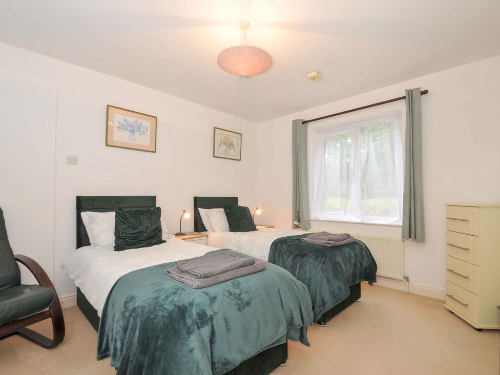 A bedroom with two beds and a dresser at Upper Court Cottage, Broad Langdon near Wainhouse Corner