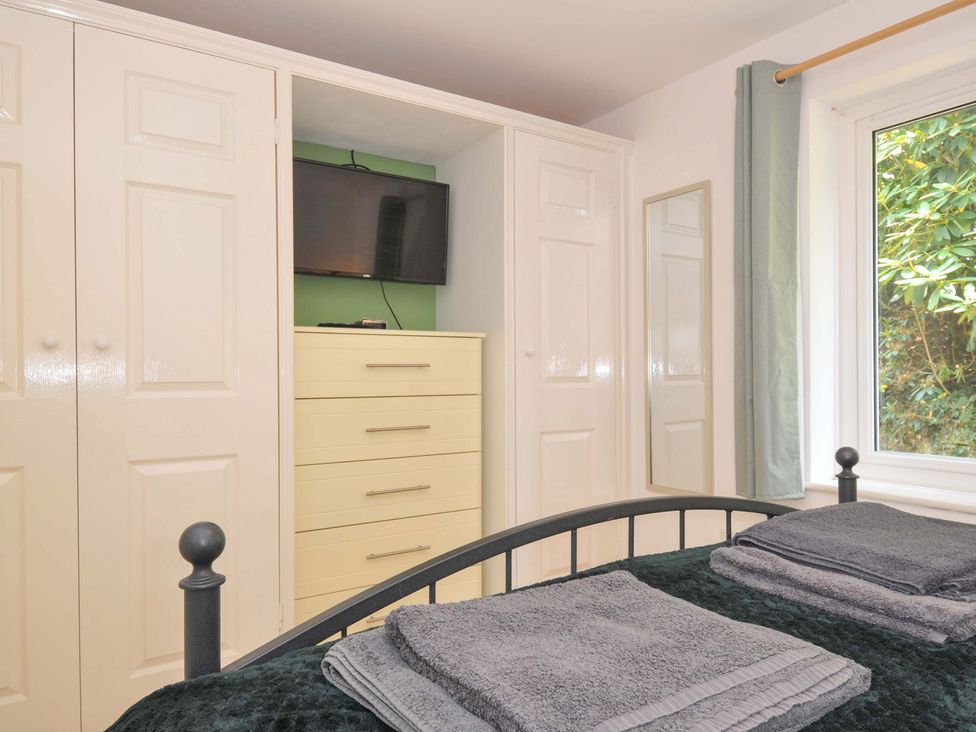 A bedroom with a bed and storage furniture at Upper Court Cottage Broad Langdon near Wainhouse Corner