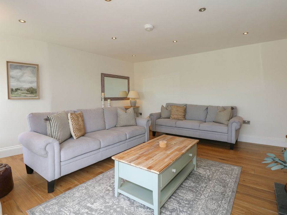 A living room with two sofas and a coffee table at Criw in Bryncroes near Sarn Meyllteyrn