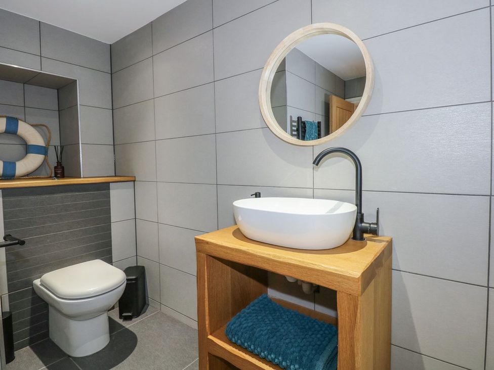 A bathroom with a sink and a toilet at Criw in Bryncroes near Sarn Meyllteyrn
