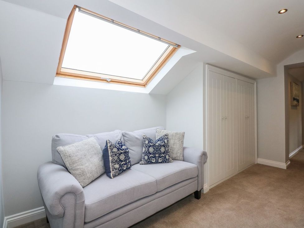 A landing with a sofa and skylight at Criw in Bryncroes near Sarn Meyllteyrn