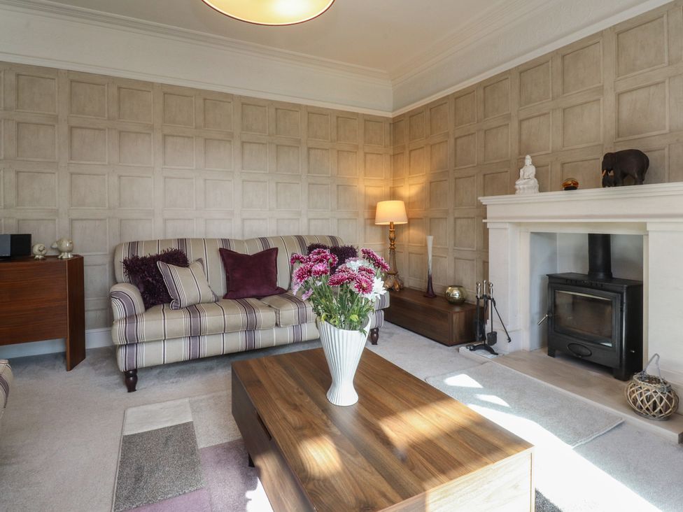A living room with a sofa and a coffee table at Langcliffe House in Kettlewell