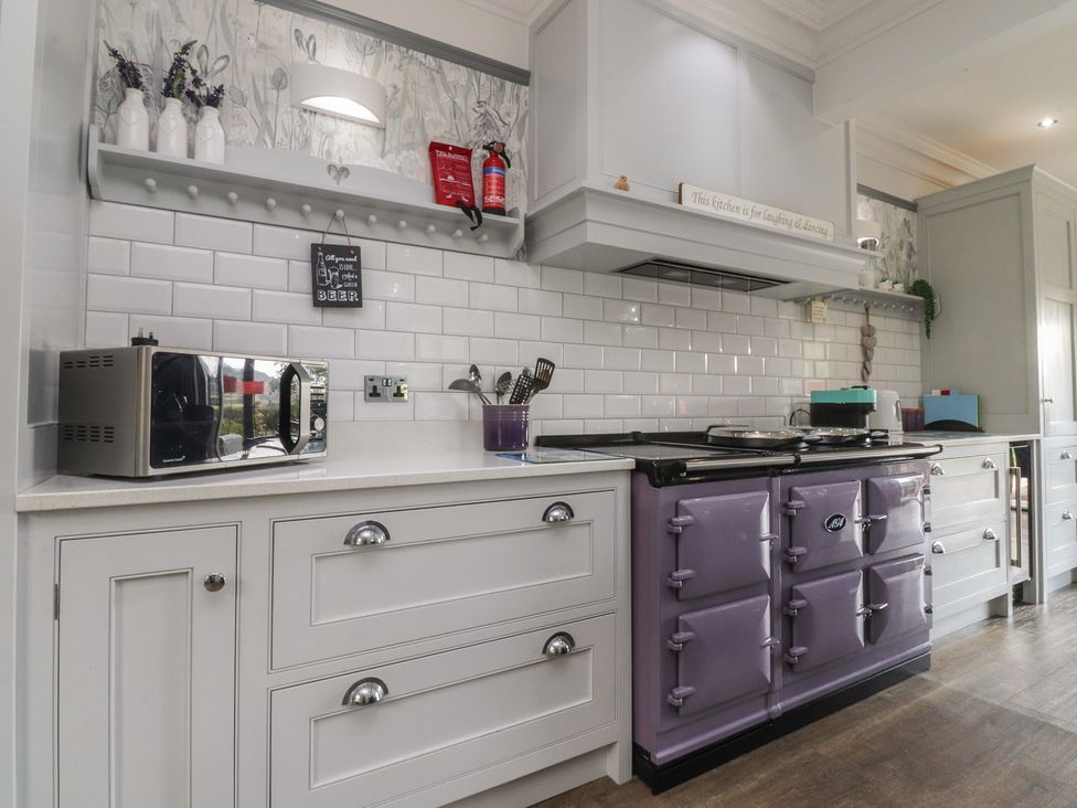 A kitchen with a purple stove and microwave at Langcliffe House Kettlewell
