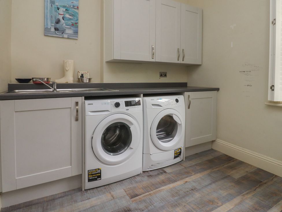 A utility room with washing machine and dryer at Langcliffe House Kettlewell