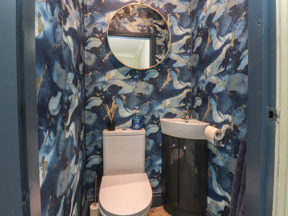 A bathroom with a toilet and sink at Langcliffe House in Kettlewell