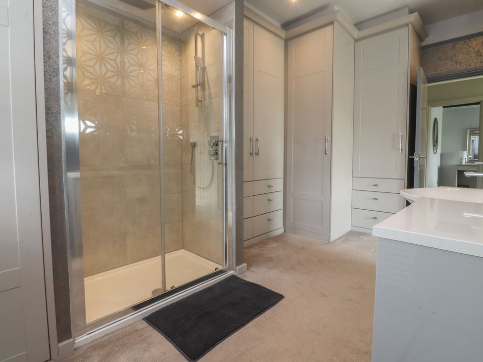 A bathroom featuring a shower and cabinets at Langcliffe House in Kettlewell