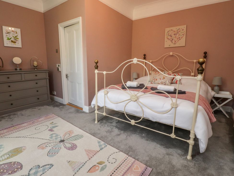 A bedroom with a bed and dresser at Langcliffe House in Kettlewell
