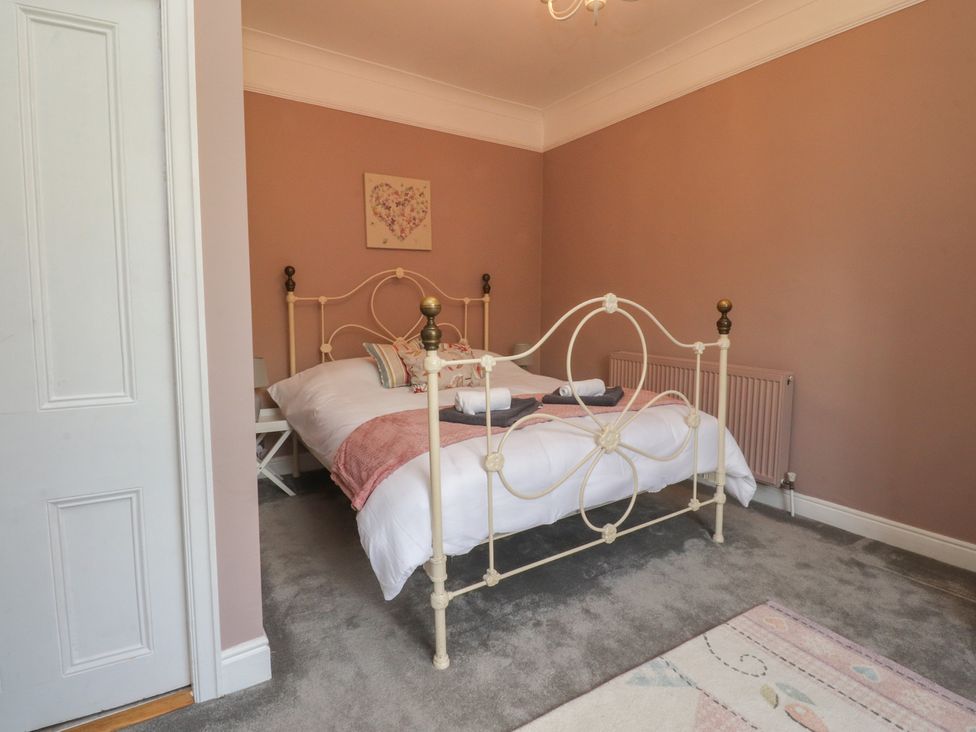 A bedroom with a bed and artwork at Langcliffe House Kettlewell