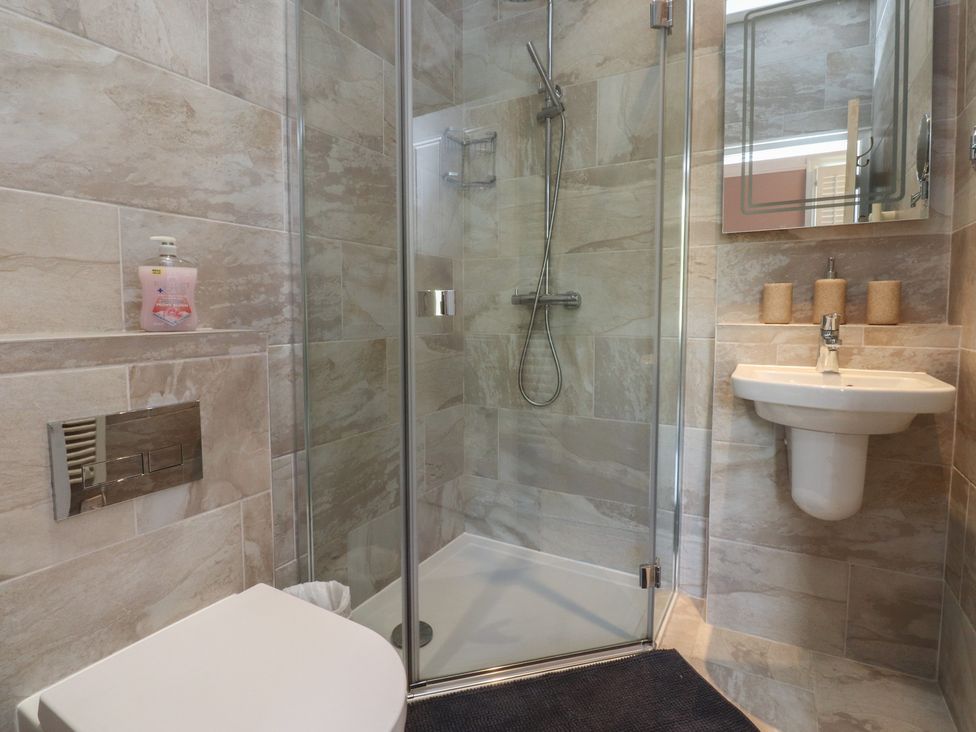 A bathroom with shower, toilet, and sink at Langcliffe House Kettlewell