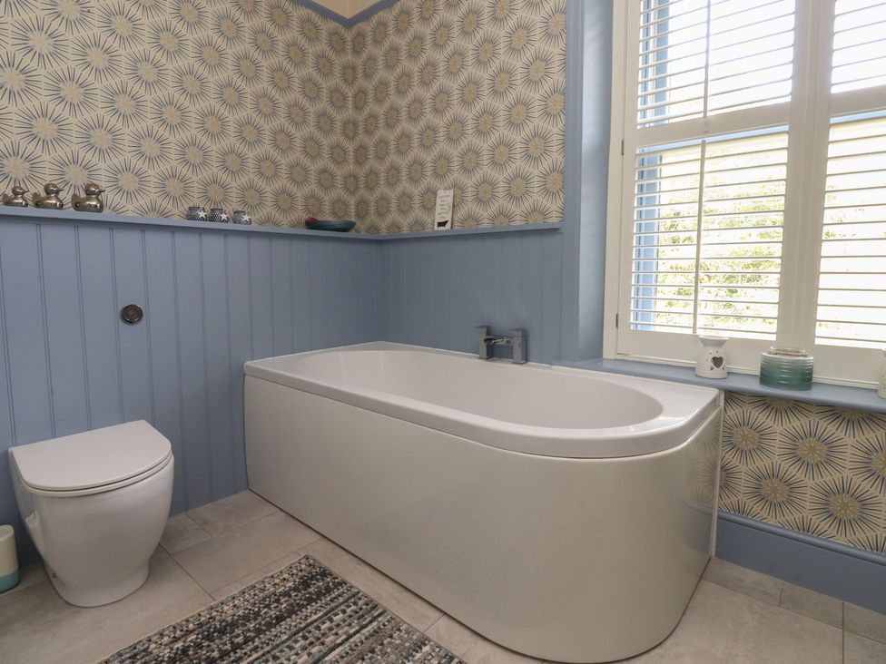 A bathroom with a bathtub and a toilet at Langcliffe House in Kettlewell