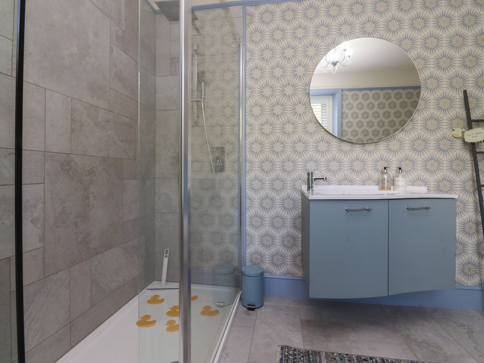 A bathroom with a shower and sink at Langcliffe House in Kettlewell