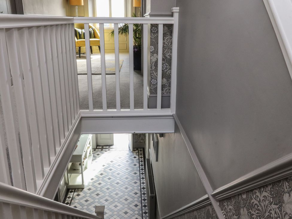 A staircase and hallway with decorative tiles at Langcliffe House Kettlewell