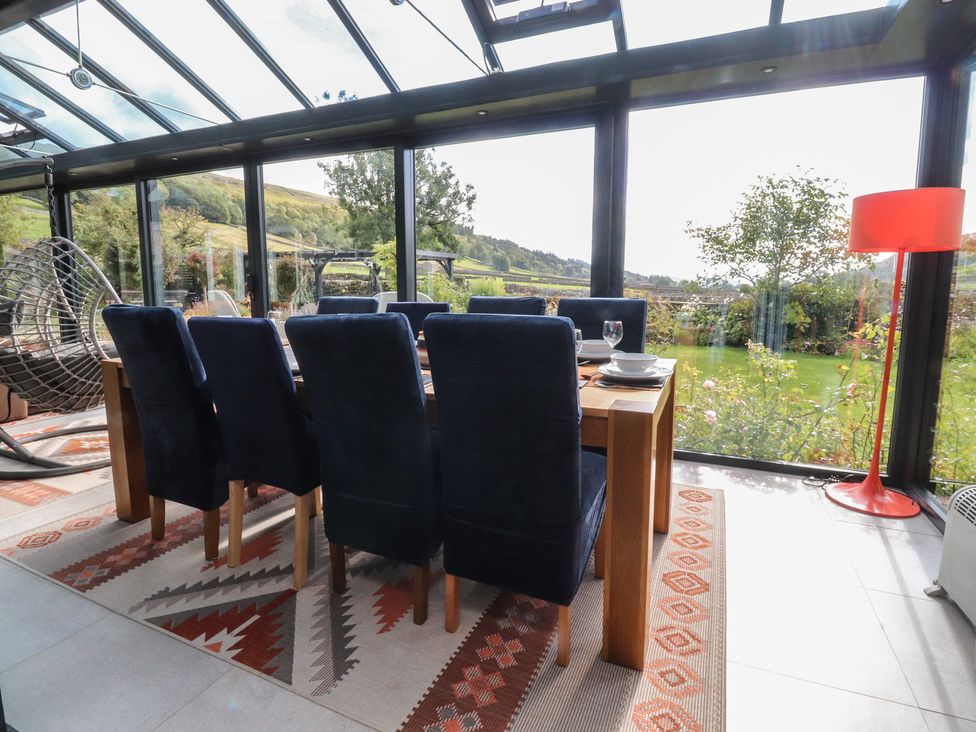 A dining area with a table and chairs at Langcliffe House in Kettlewell