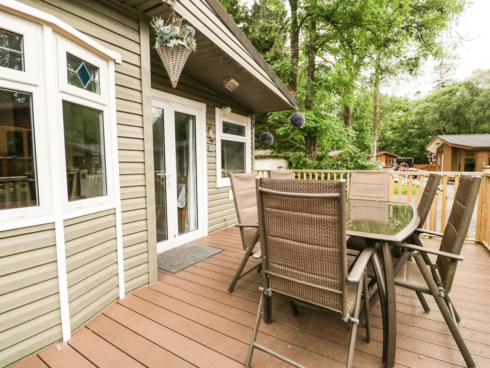 An outdoor seating area with a table and chairs at Owls Nook Lodge, Langdale 9, White Cross Bay near Windermere