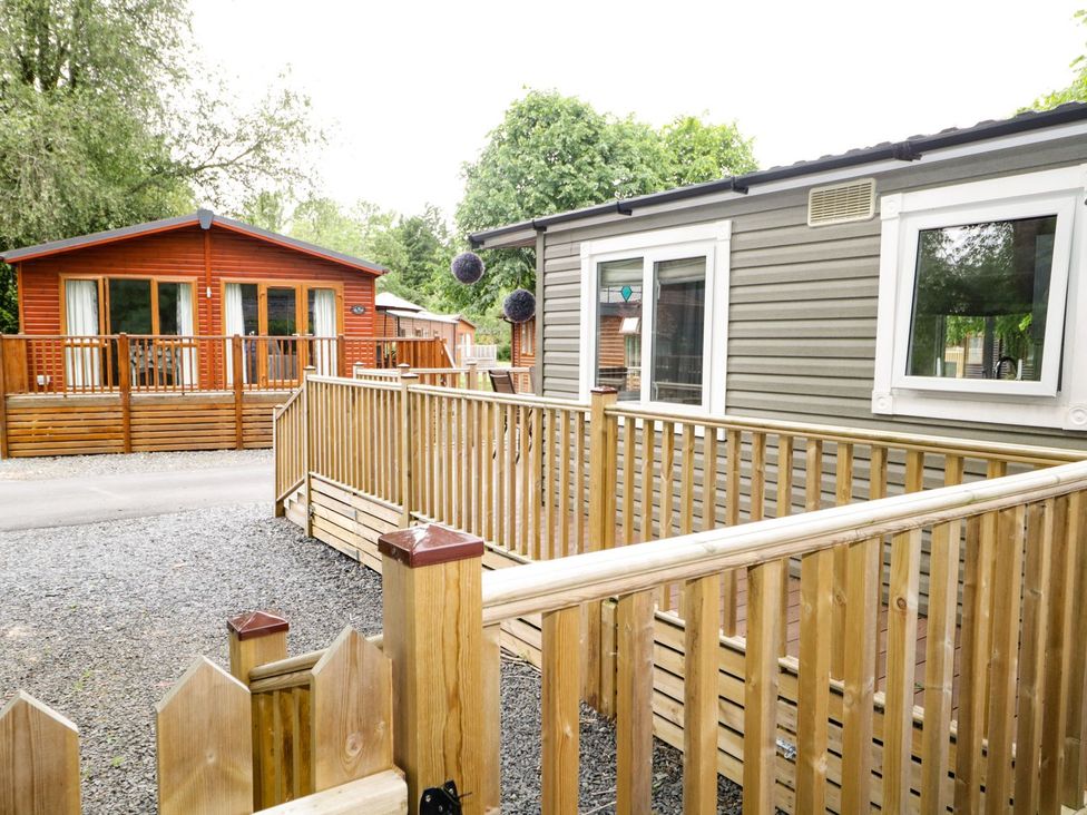An outdoor area with mobile homes and a wooden deck at Owls Nook Lodge Langdale 9 White Cross Bay near Windermere