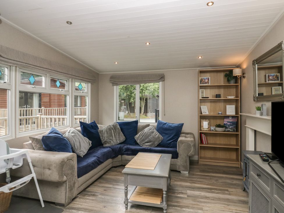 A living room with a sofa and coffee table at Owls Nook Lodge, Langdale 9, White Cross Bay near Windermere