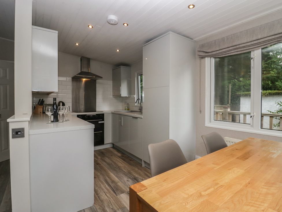 A kitchen with a table and chairs at Owls Nook Lodge, Langdale 9, White Cross Bay near Windermere