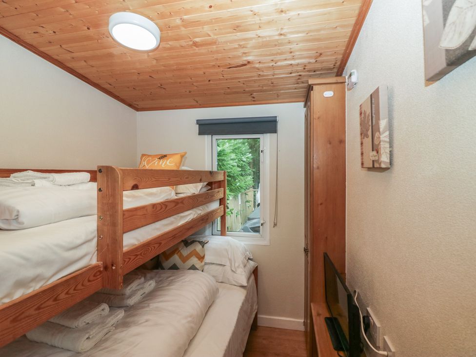 A bedroom with a bunk bed and wardrobe at Owls Nook Lodge Langdale 9, White Cross Bay near Windermere