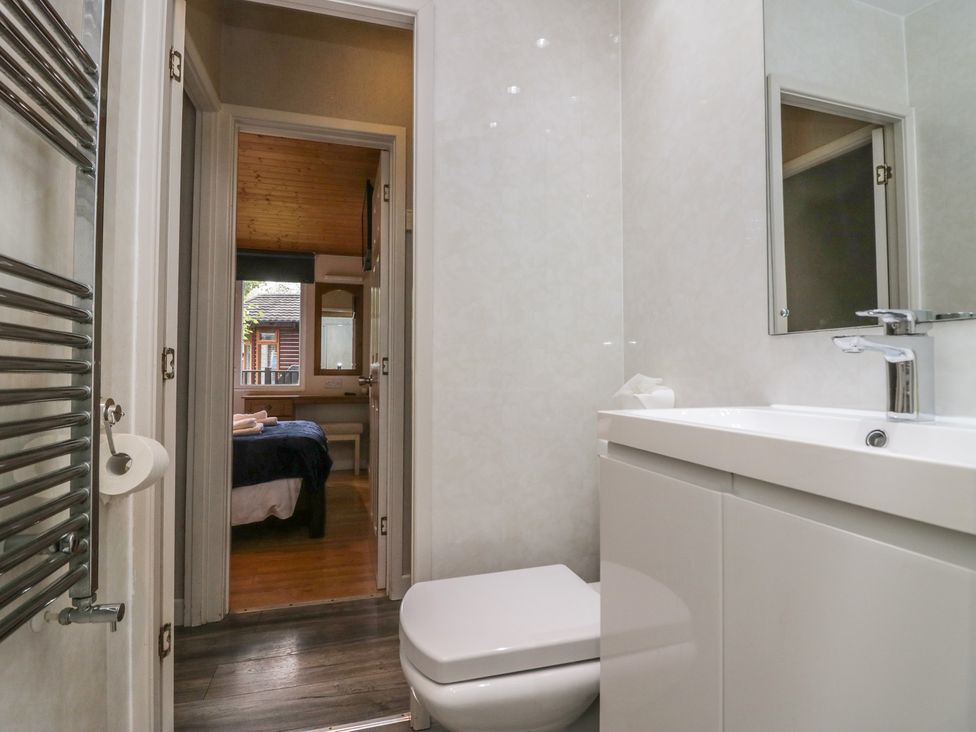 A bathroom with a toilet and sink at Owls Nook Lodge Langdale 9, White Cross Bay near Windermere