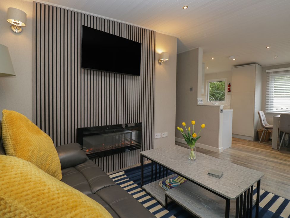A living room with a sofa and coffee table at Owls Nook Lodge, Langdale 9, White Cross Bay near Windermere