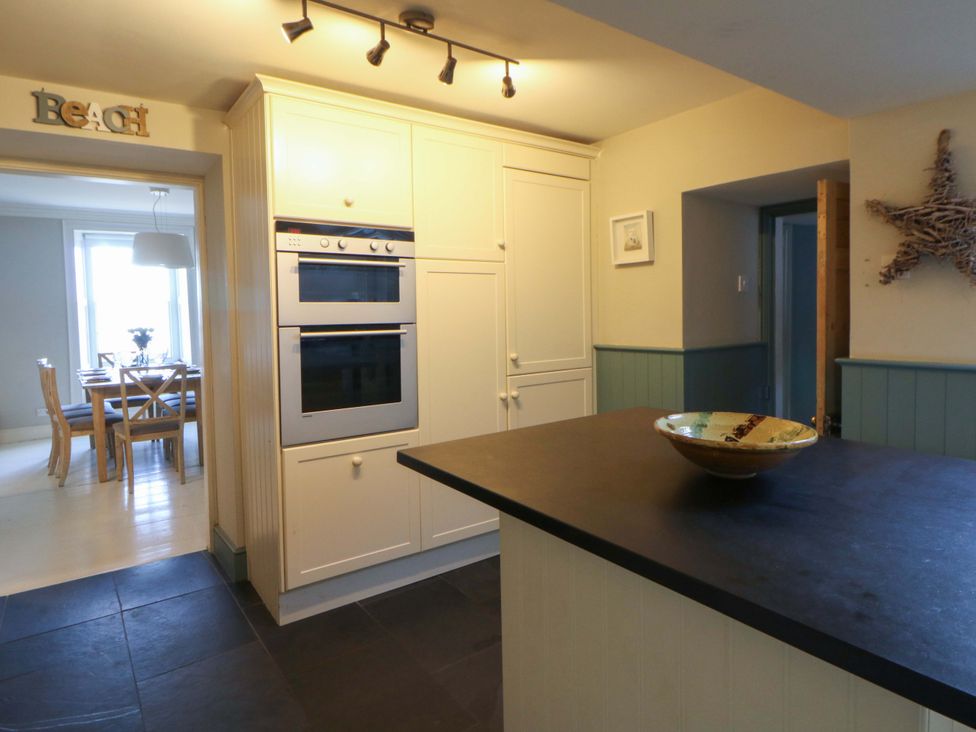 A kitchen with ovens and cabinets at Zenobia in New Quay