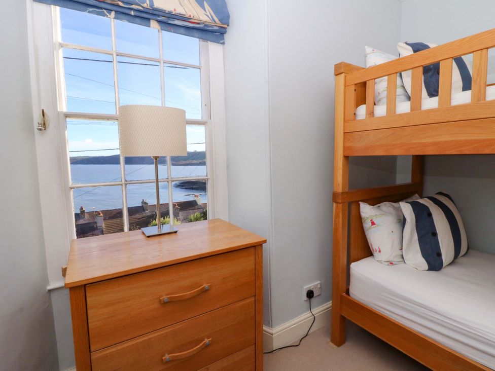 A bedroom with a bunk bed and lamp at Zenobia in New Quay