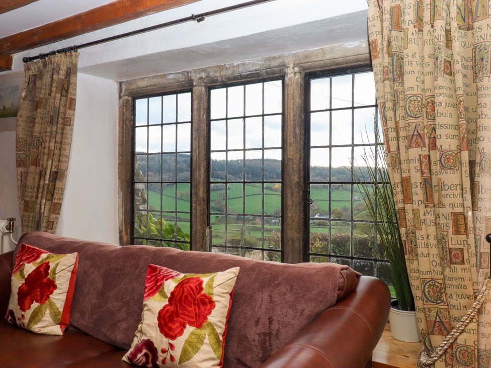 A living room with a window and sofa at Higher Wadden Farm in Southleigh