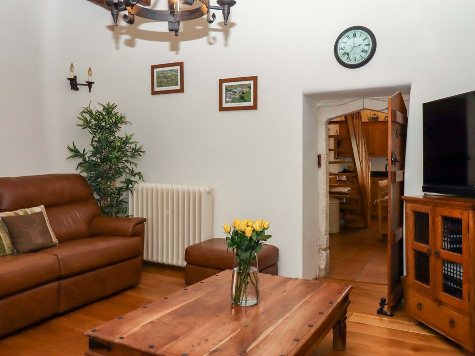 A living room with a sofa and coffee table at Higher Wadden Farm in Southleigh
