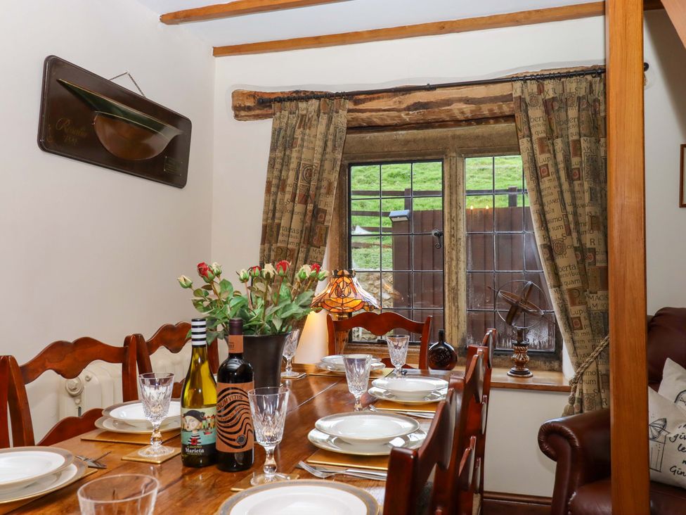 A dining room with a table set for dinner at Higher Wadden Farm in Southleigh