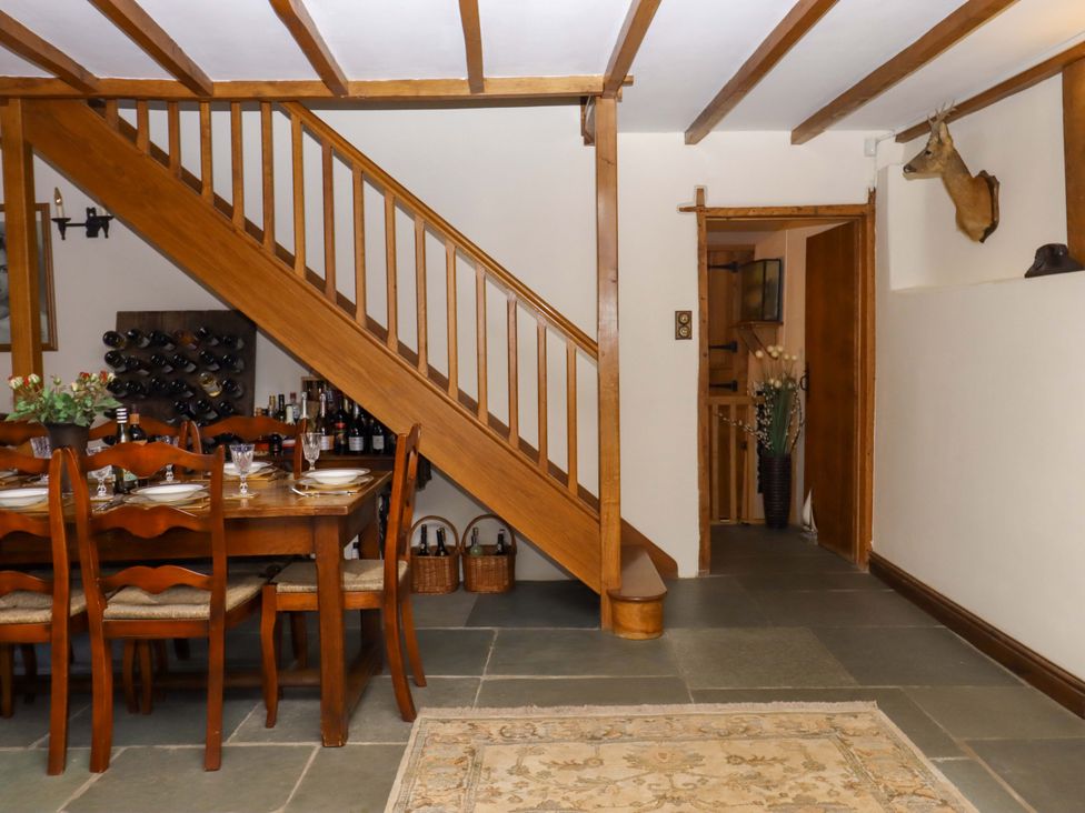 A dining room with a table and chairs at Higher Wadden Farm Southleigh