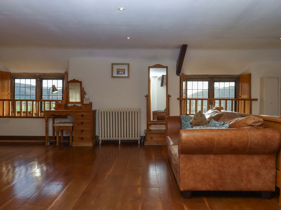 A living room with a sofa and table at Higher Wadden Farm Southleigh