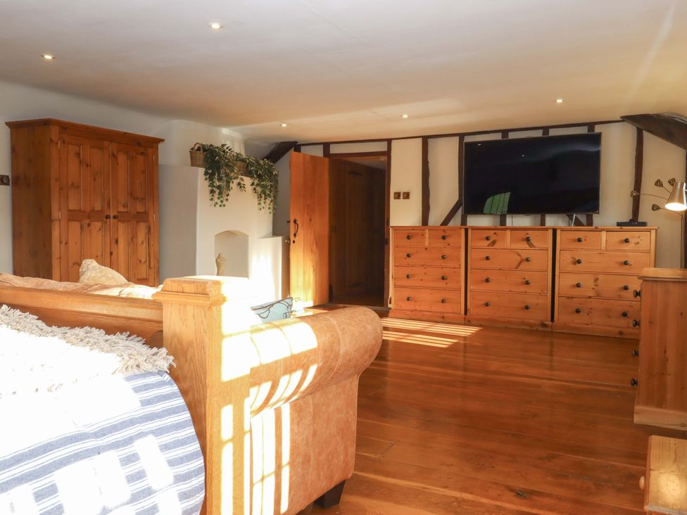 A living room with a sofa and television at Higher Wadden Farm in Southleigh