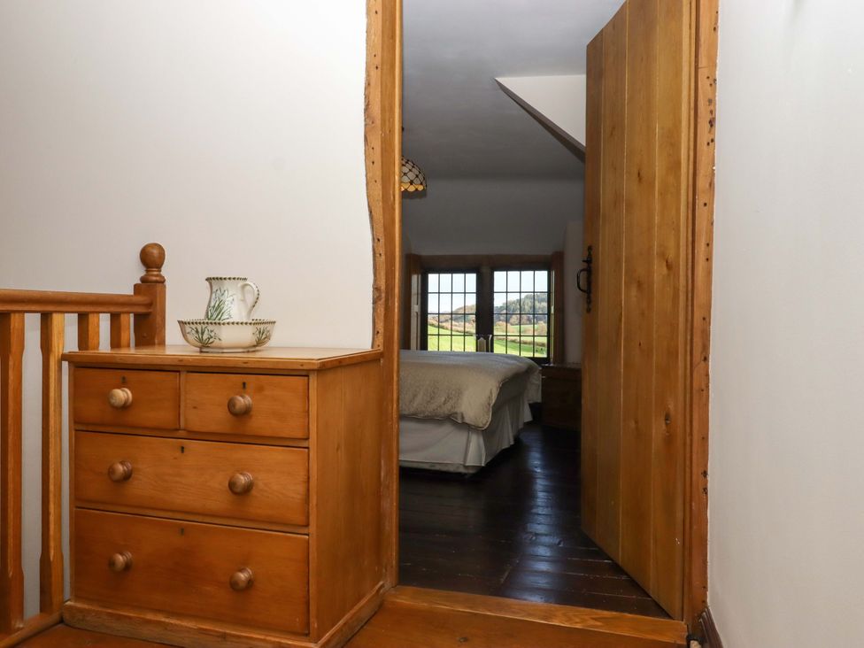 A hallway leading to a bedroom at Higher Wadden Farm in Southleigh