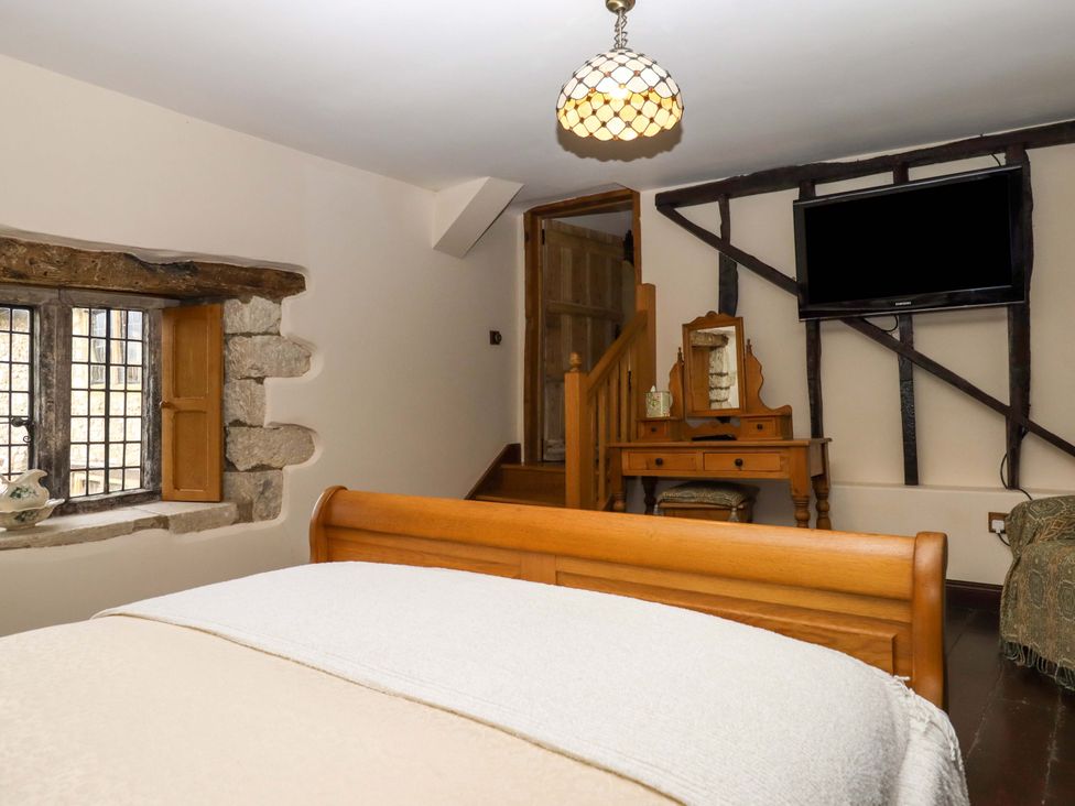 A bedroom with a bed and window at Higher Wadden Farm Southleigh