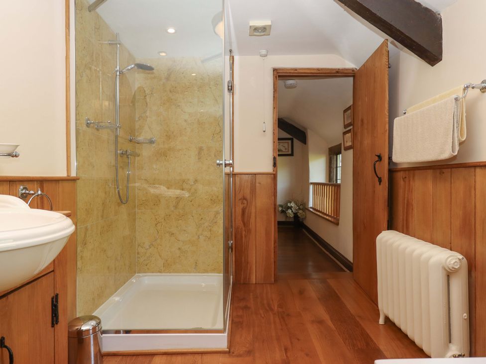 A bathroom with shower and sink at Higher Wadden Farm in Southleigh