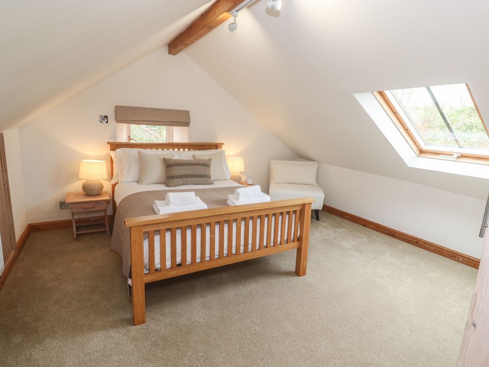 A bedroom with a bed and skylight at Riverside Barn Stithians